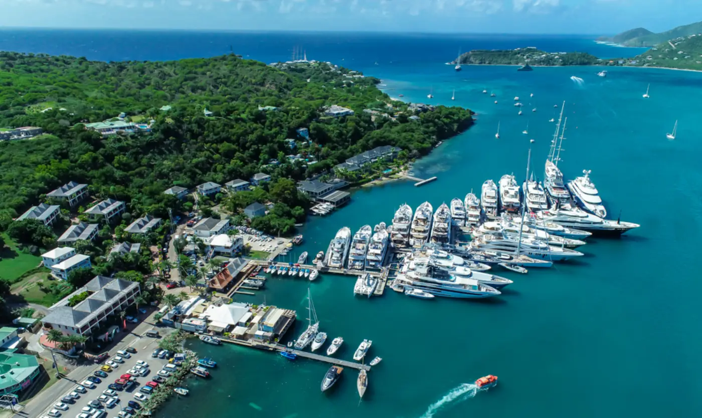 Aerial view of superyachts berthed in Falmouth Harbour with the Antiguan hills beyond